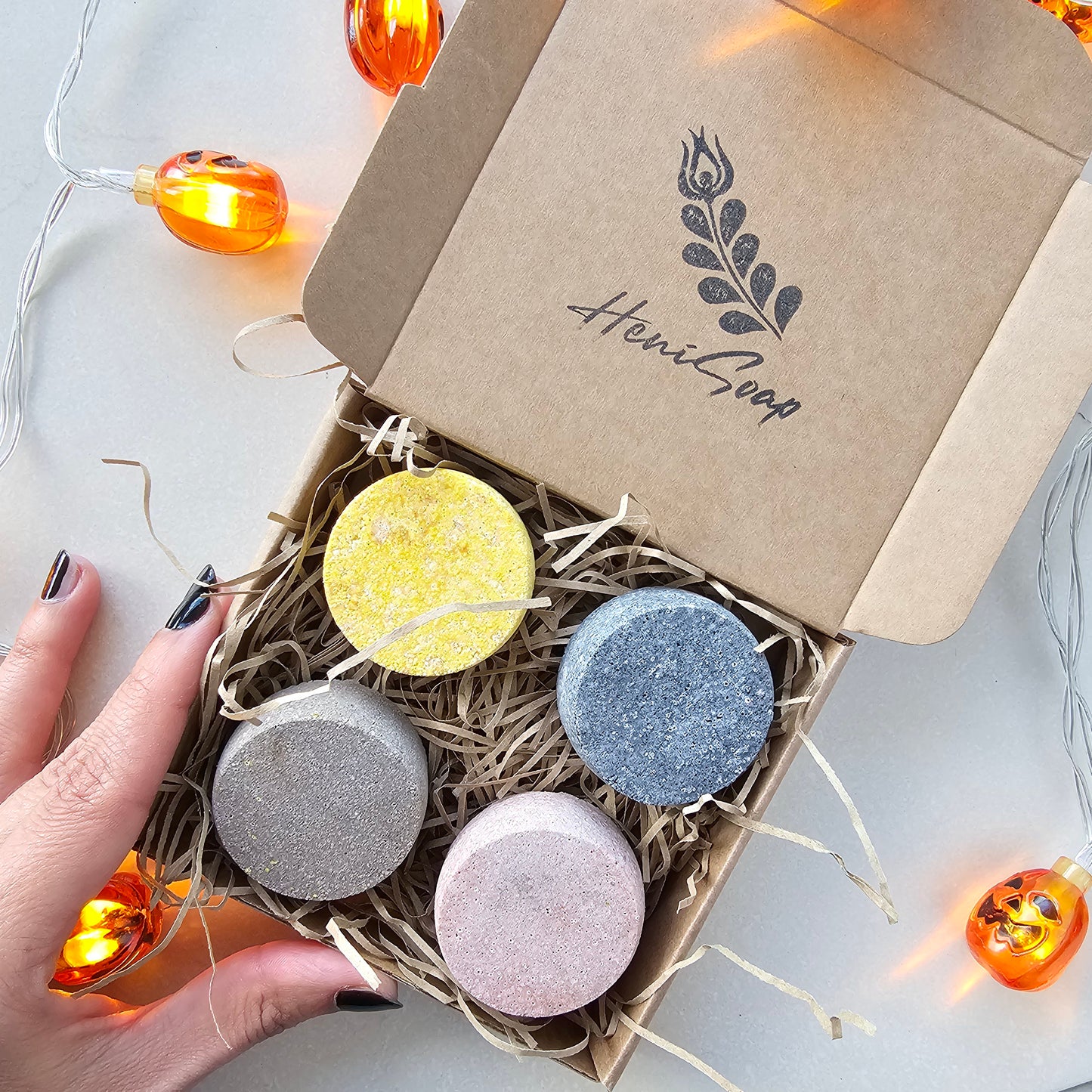 Box of colorful shower steamers with 'Heni Goop' branding on a light background.
