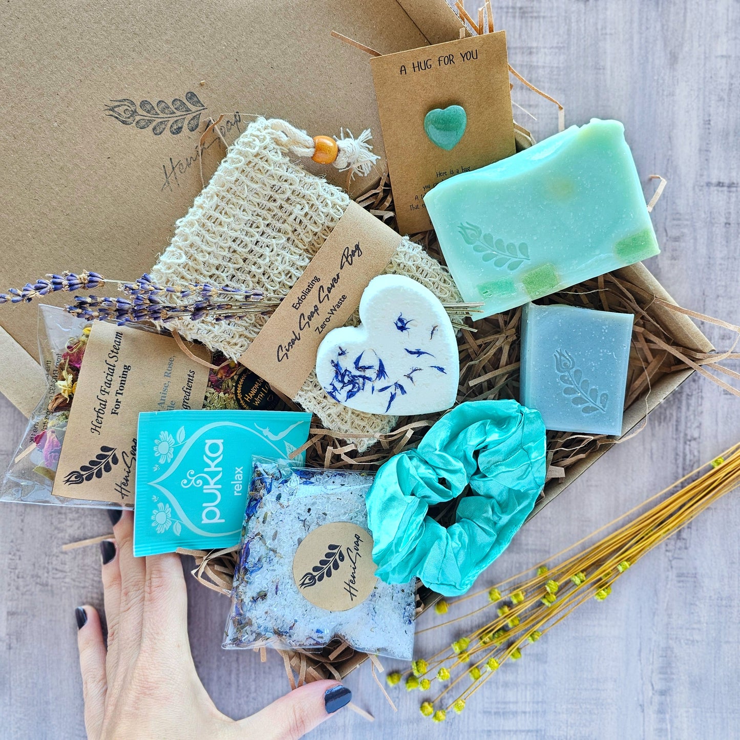 Handmade soap and skincare products in a lavender-themed box.