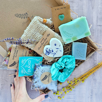 Handmade soap and skincare products in a lavender-themed box.