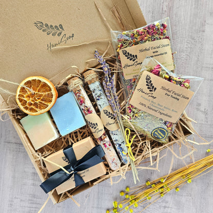 Gift basket with soaps, saltss, and facial steams on a textured surface