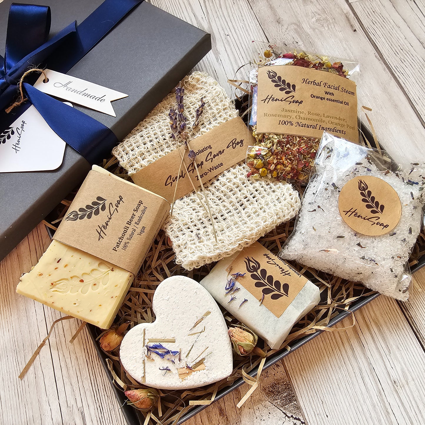 Box of handmade soaps with natural ingredients on a wooden surface