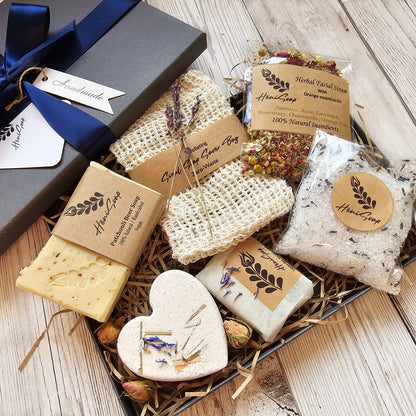 Box of handmade soaps with natural ingredients on a wooden surface