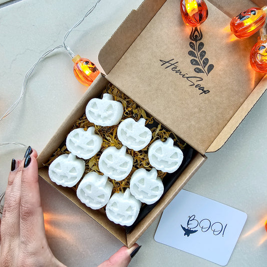 Box of white Halloween-themed bath bombs with decorative lights and a 'BOO!' card.