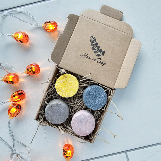 Box of colorful shower steamers with a string of lights 